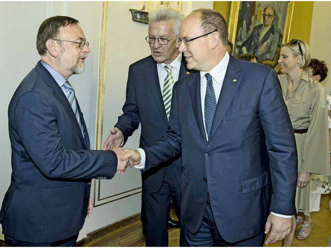 Dr. Kulitz in conversation with Prince Albert II of Monaco and Winfried Kretschmann.